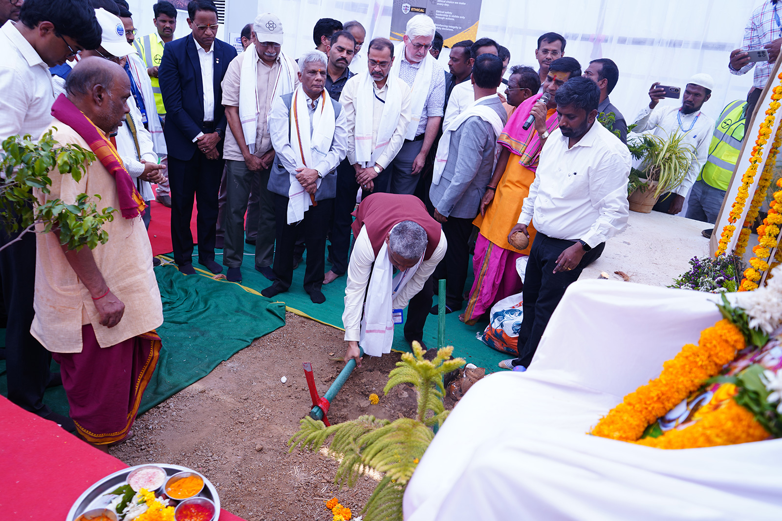 Engineer Sameer Jadhav breaks ground at the site of the future LIGO-India gravitational-wave observatory as officials and scientists look on