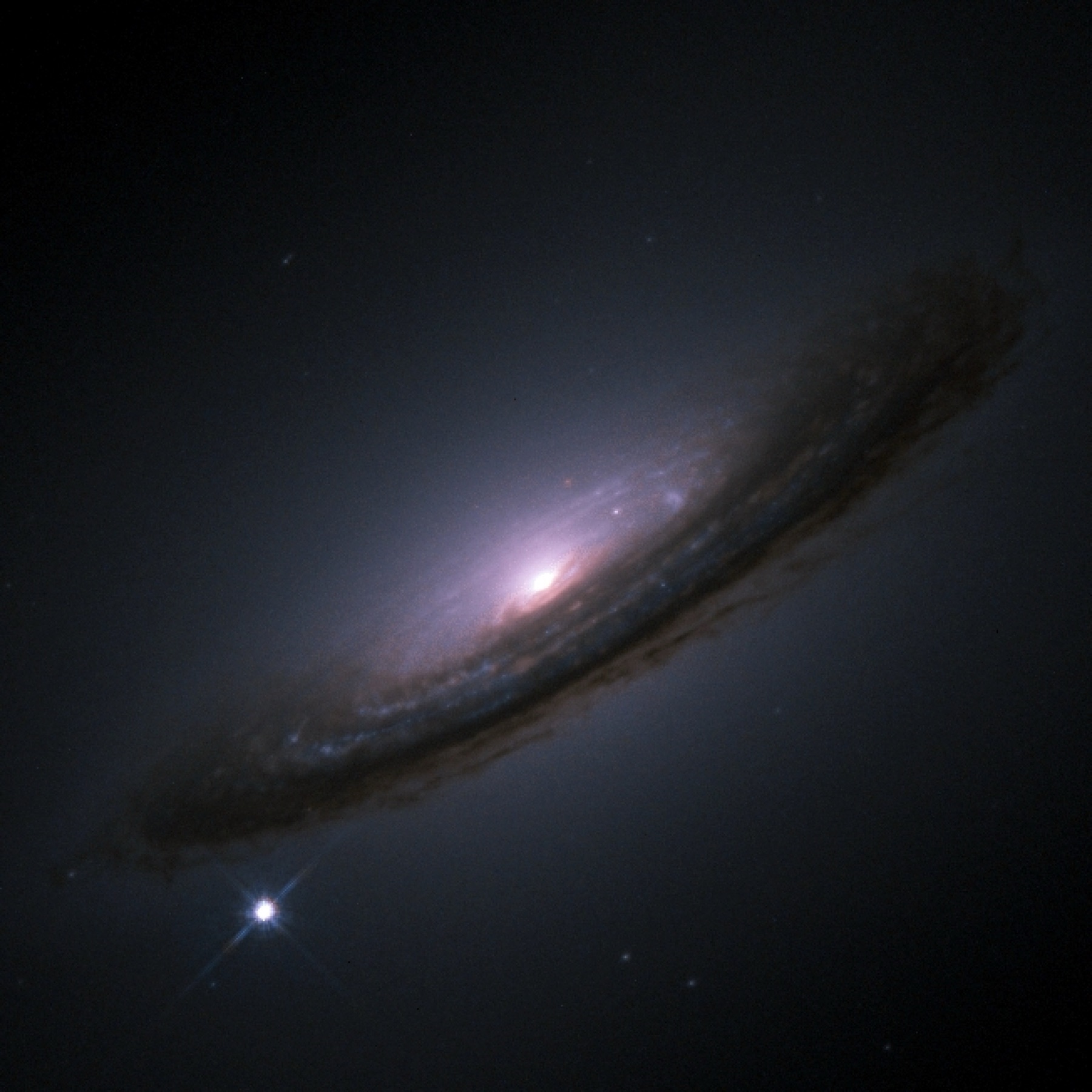Hubble image of the galaxy NGC 4526 with the bright Type Ia supernova SN 1994D shining as a point at its lower left
