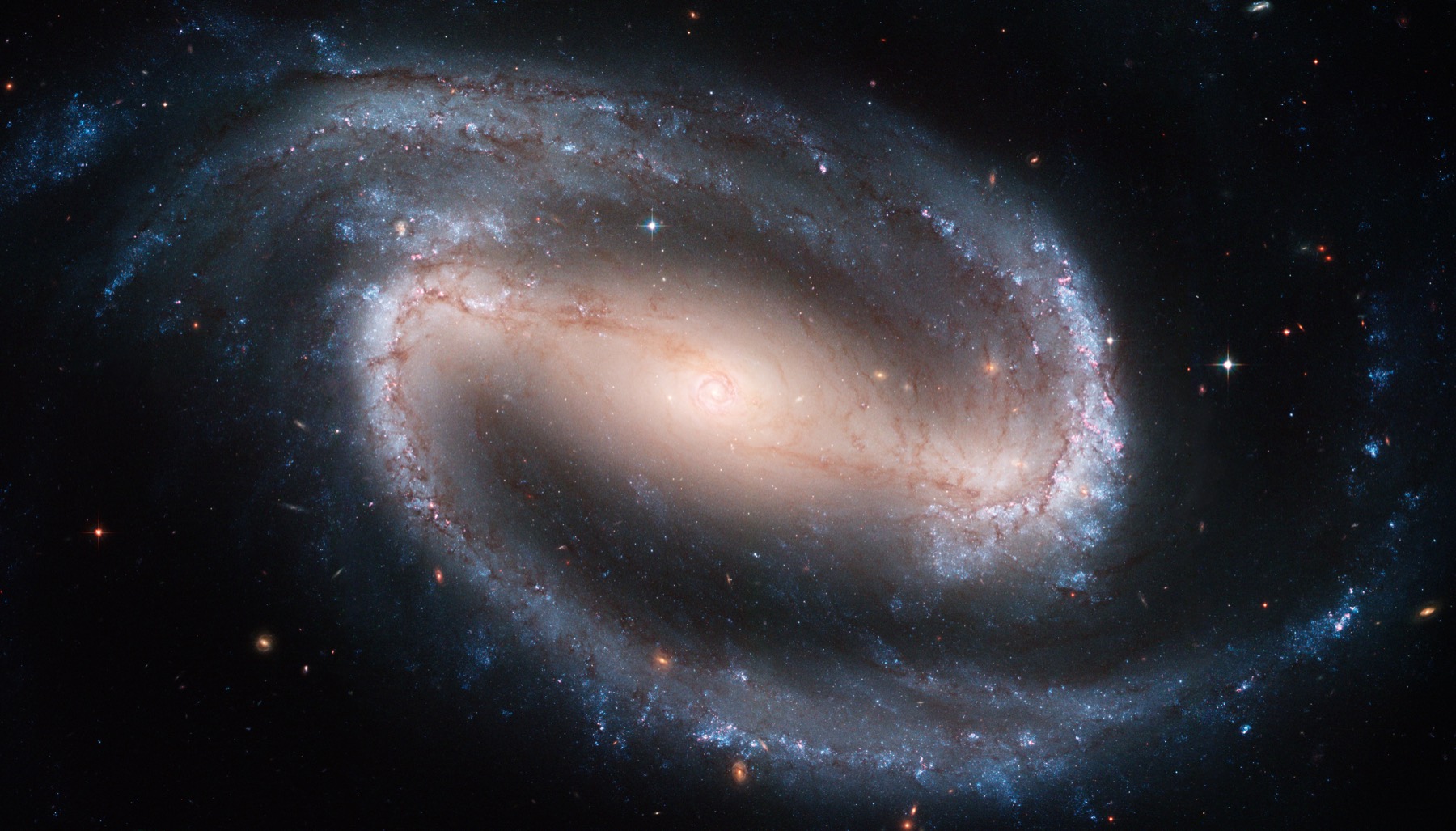 Hubble image of the barred spiral galaxy NGC 1300, one of the classic types of galaxies, with a bright central bar and two sweeping blue spiral arms