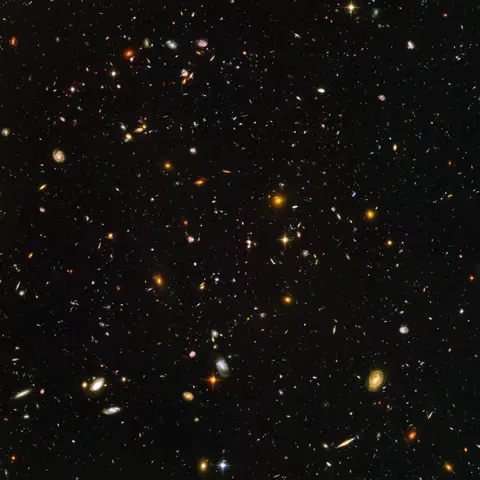 The Hubble Ultra Deep Field: thousands of galaxies of every shape and color in a tiny patch of dark sky.