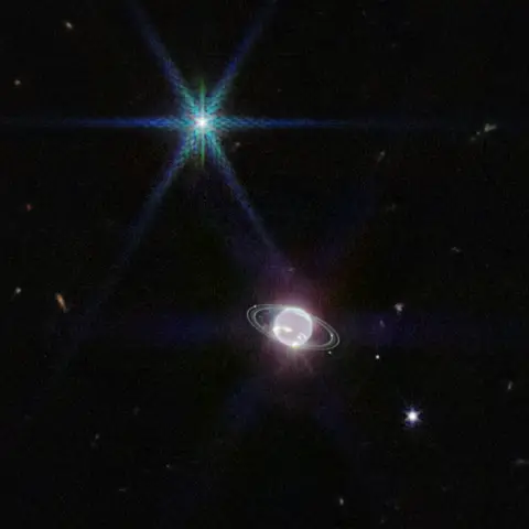 Neptune and its thin rings seen by Webb, with the moon Triton shining as a bright diffraction-spiked point.